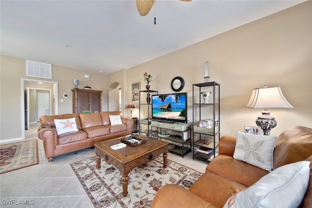 tiled living room with ceiling fan