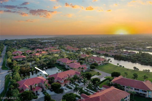 aerial view at dusk with a water view