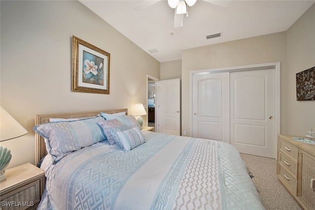 bedroom featuring ceiling fan, light colored carpet, and a closet