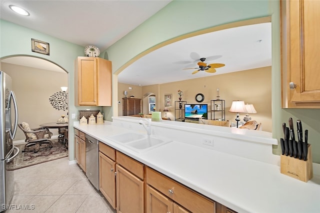 kitchen featuring ceiling fan, sink, light tile patterned flooring, and appliances with stainless steel finishes