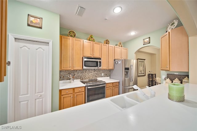 kitchen featuring decorative backsplash, sink, stainless steel appliances, and light brown cabinetry