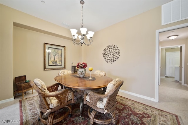 dining area with light tile patterned floors and an inviting chandelier