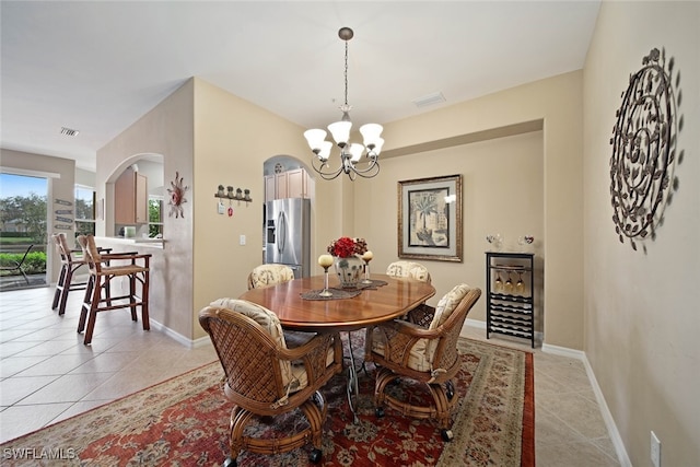 tiled dining area featuring a notable chandelier