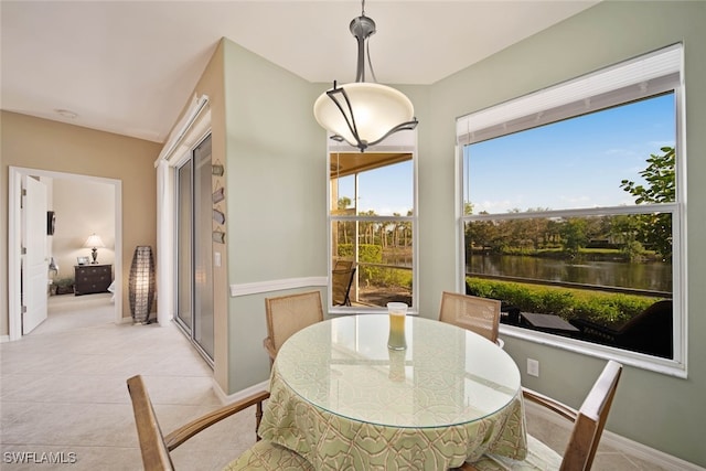 tiled dining space with a water view