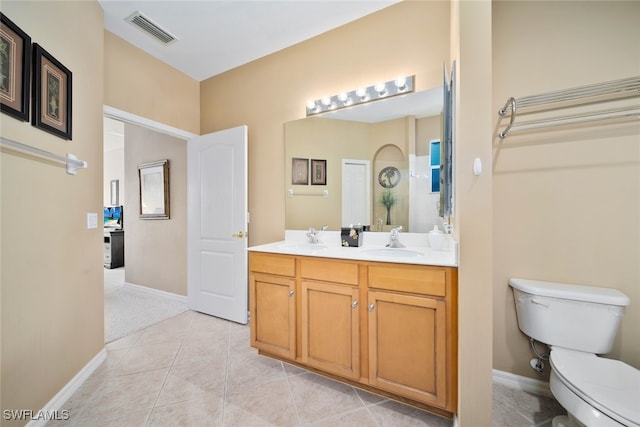 bathroom with tile patterned floors, vanity, and toilet