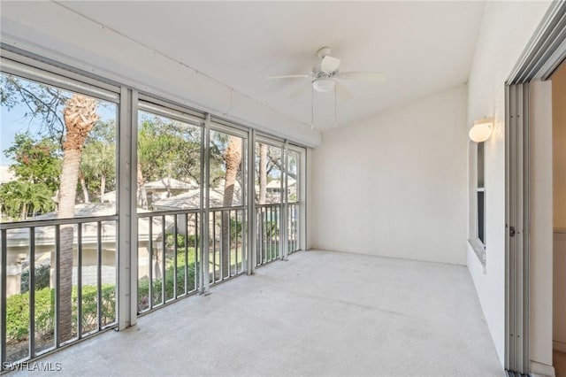 unfurnished sunroom featuring ceiling fan and a wealth of natural light