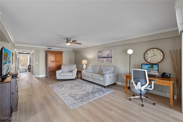 living room with light hardwood / wood-style flooring, ceiling fan, and ornamental molding