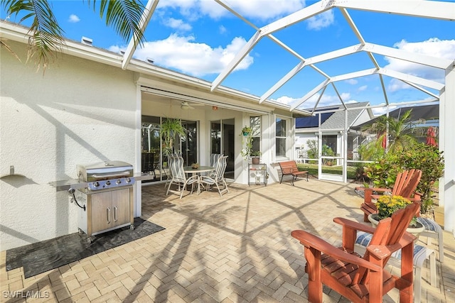 view of patio / terrace with ceiling fan, a lanai, and a grill