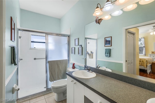 bathroom with toilet, vanity, tile patterned floors, and an enclosed shower