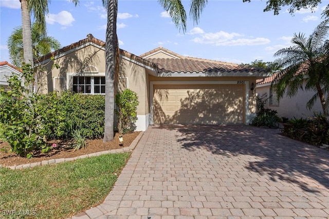 mediterranean / spanish-style home with a garage