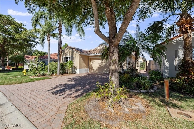 view of front of property featuring a front yard and a garage