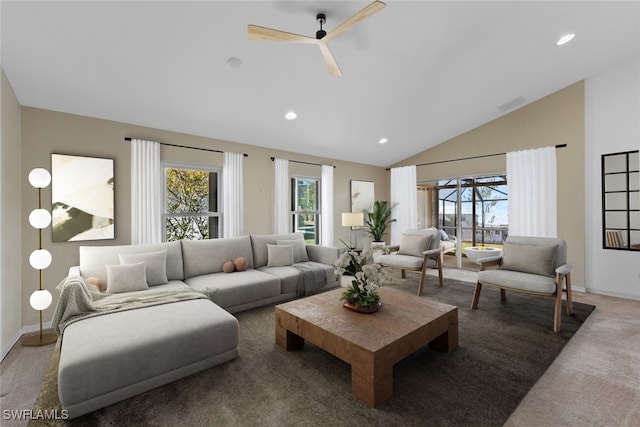 carpeted living room with ceiling fan and lofted ceiling