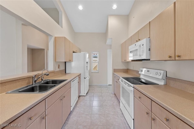 kitchen featuring light brown cabinets, sink, high vaulted ceiling, white appliances, and light tile patterned flooring