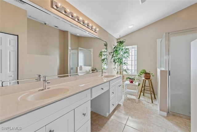 bathroom with tile patterned flooring, vanity, lofted ceiling, and a shower with door