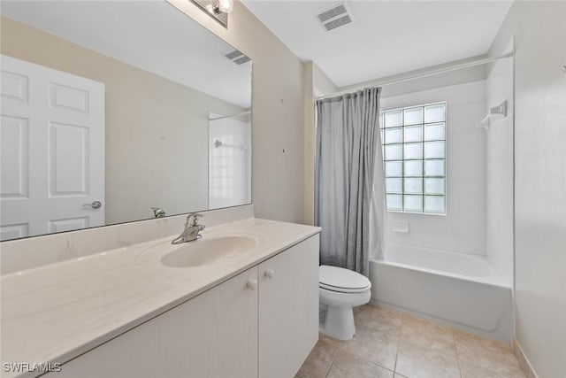 full bathroom with tile patterned flooring, shower / tub combo, vanity, and toilet