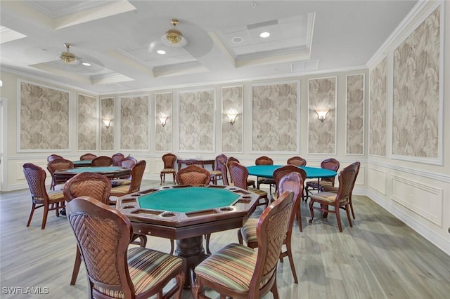 recreation room with hardwood / wood-style floors, ceiling fan, crown molding, and coffered ceiling