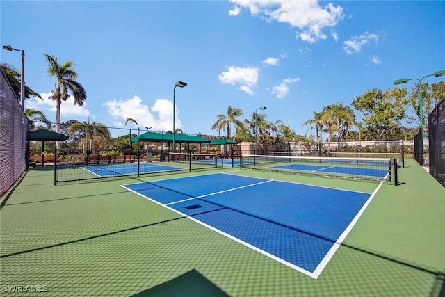 view of tennis court featuring basketball hoop