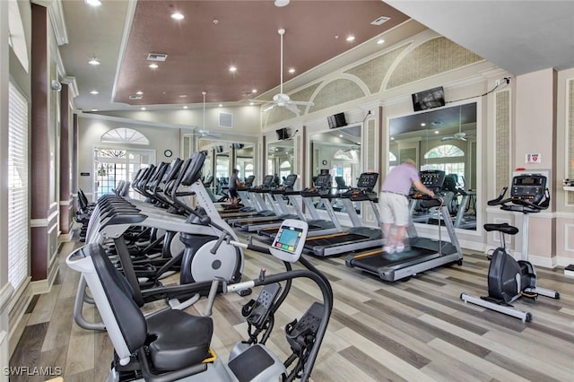 workout area featuring ceiling fan and light wood-type flooring