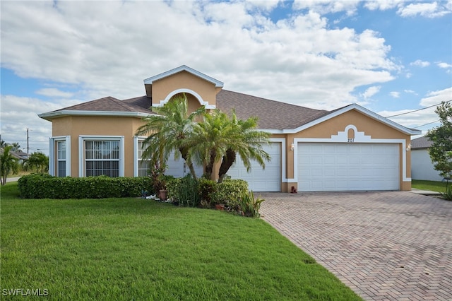 view of front of home featuring a front lawn and a garage