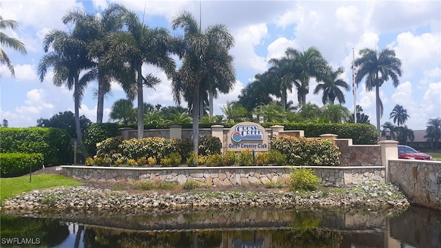 community sign featuring a water view