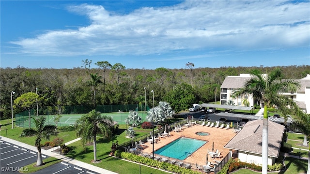 view of swimming pool with tennis court