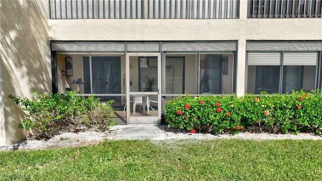 entrance to property featuring a yard