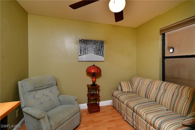 living room with light wood-type flooring and ceiling fan