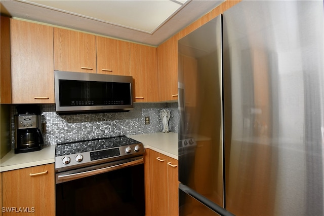 kitchen with backsplash and stainless steel appliances