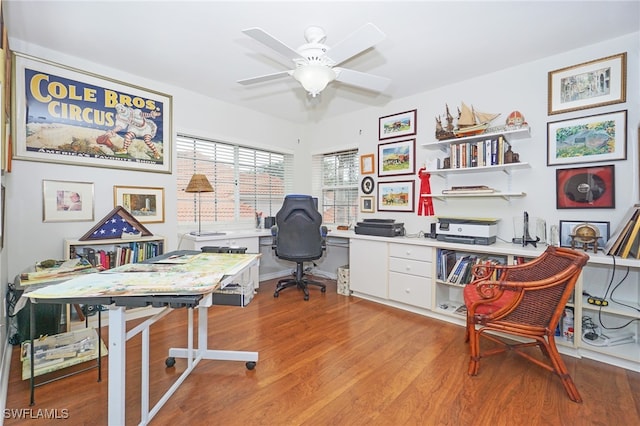 home office with light wood-type flooring and ceiling fan