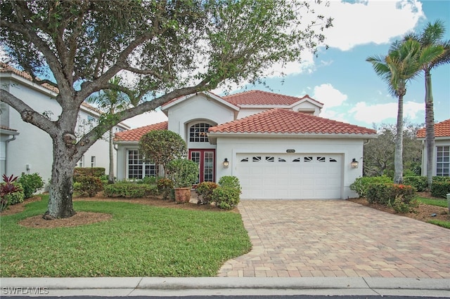 mediterranean / spanish-style home with a garage and a front yard