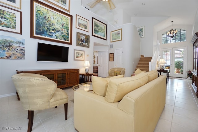 living room featuring a chandelier, light tile patterned floors, high vaulted ceiling, and french doors