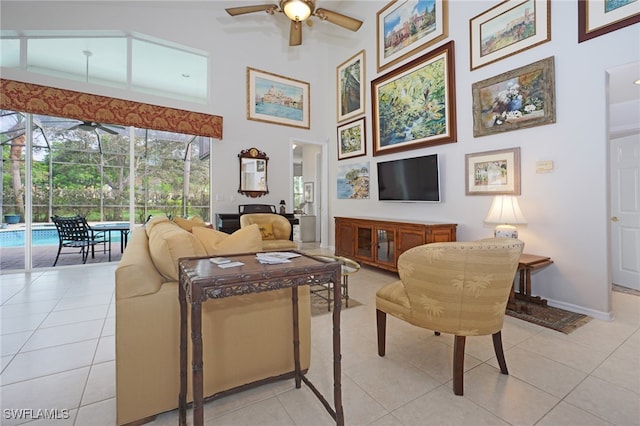 living room with ceiling fan, light tile patterned floors, and high vaulted ceiling