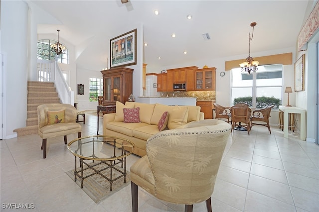 tiled living room with vaulted ceiling and an inviting chandelier