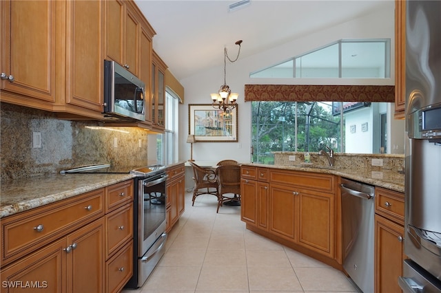 kitchen featuring an inviting chandelier, hanging light fixtures, vaulted ceiling, light stone countertops, and stainless steel appliances