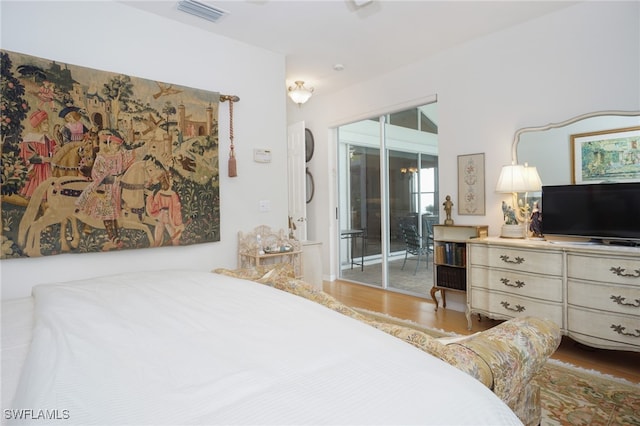 bedroom featuring access to exterior and wood-type flooring