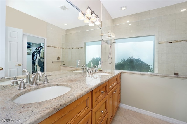 bathroom featuring vanity, tile patterned floors, and a healthy amount of sunlight