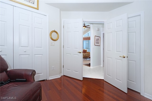 living area with ceiling fan and hardwood / wood-style floors