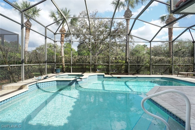 view of swimming pool featuring glass enclosure and an in ground hot tub