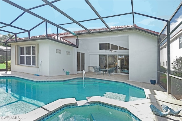 view of swimming pool featuring ceiling fan, a patio, and glass enclosure