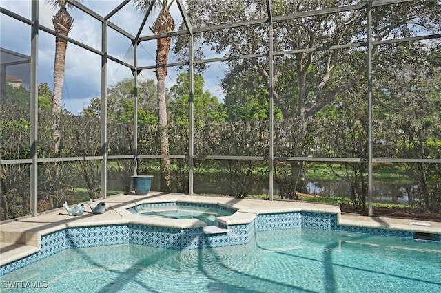 view of pool featuring an in ground hot tub and glass enclosure