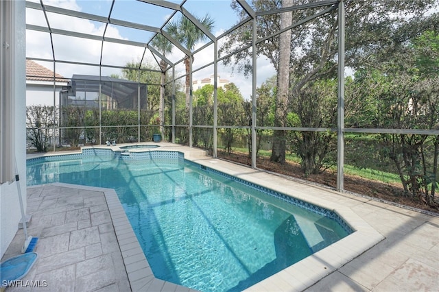 view of swimming pool featuring glass enclosure, an in ground hot tub, and a patio