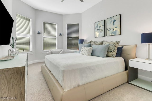 bedroom with ceiling fan and light colored carpet