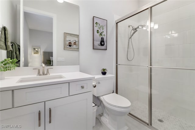 bathroom with vanity, toilet, and an enclosed shower