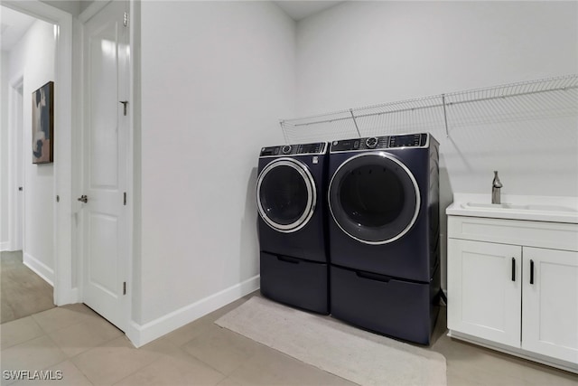 laundry area with separate washer and dryer and sink