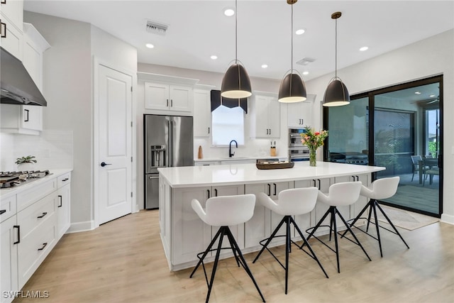 kitchen featuring decorative backsplash, sink, hanging light fixtures, and a wealth of natural light