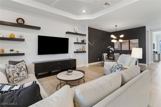 living room featuring a chandelier and light wood-type flooring