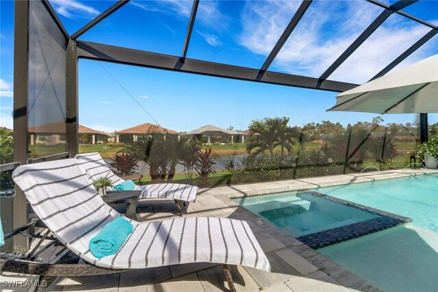 view of swimming pool featuring a water view and a patio