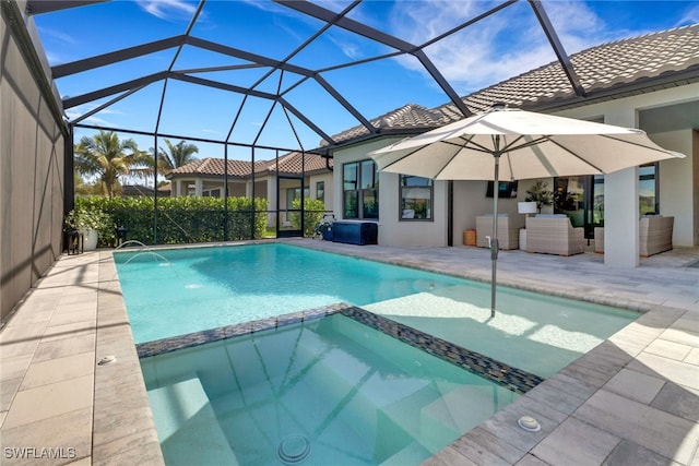 view of swimming pool featuring a lanai, an outdoor living space, and a patio area