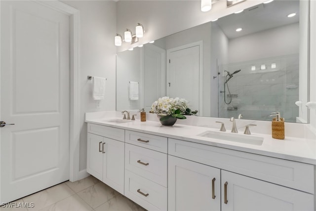 bathroom with vanity and a shower with shower door