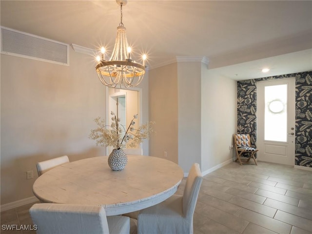 dining room with a notable chandelier and ornamental molding